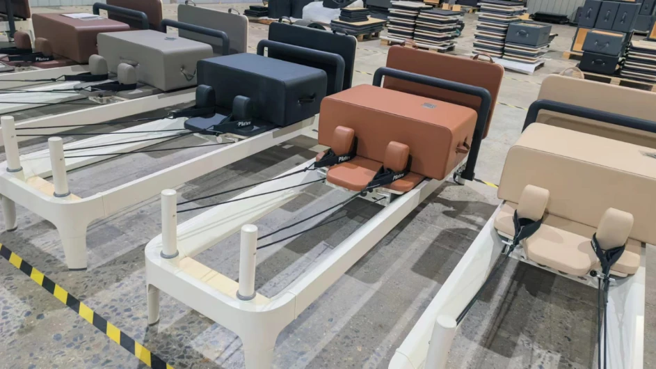 Pilates Reformers with different upholstery colors at the Yichuan factory