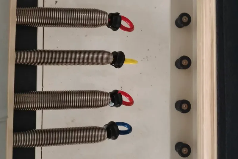 Installed Pilates equipment springs and connection hardware