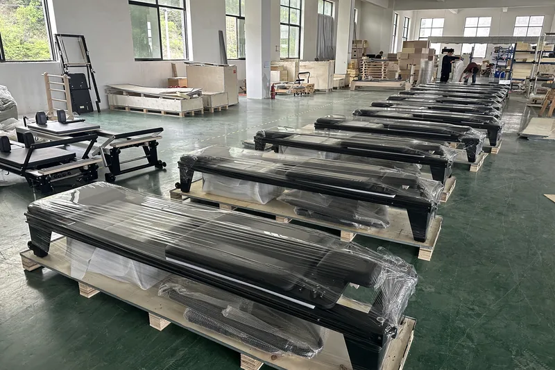 Bulk Pilates equipment protected with wrapping before packing